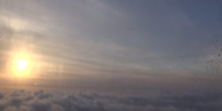 Plane Flying Above The Clouds