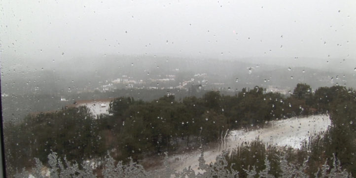 snow falling against a window